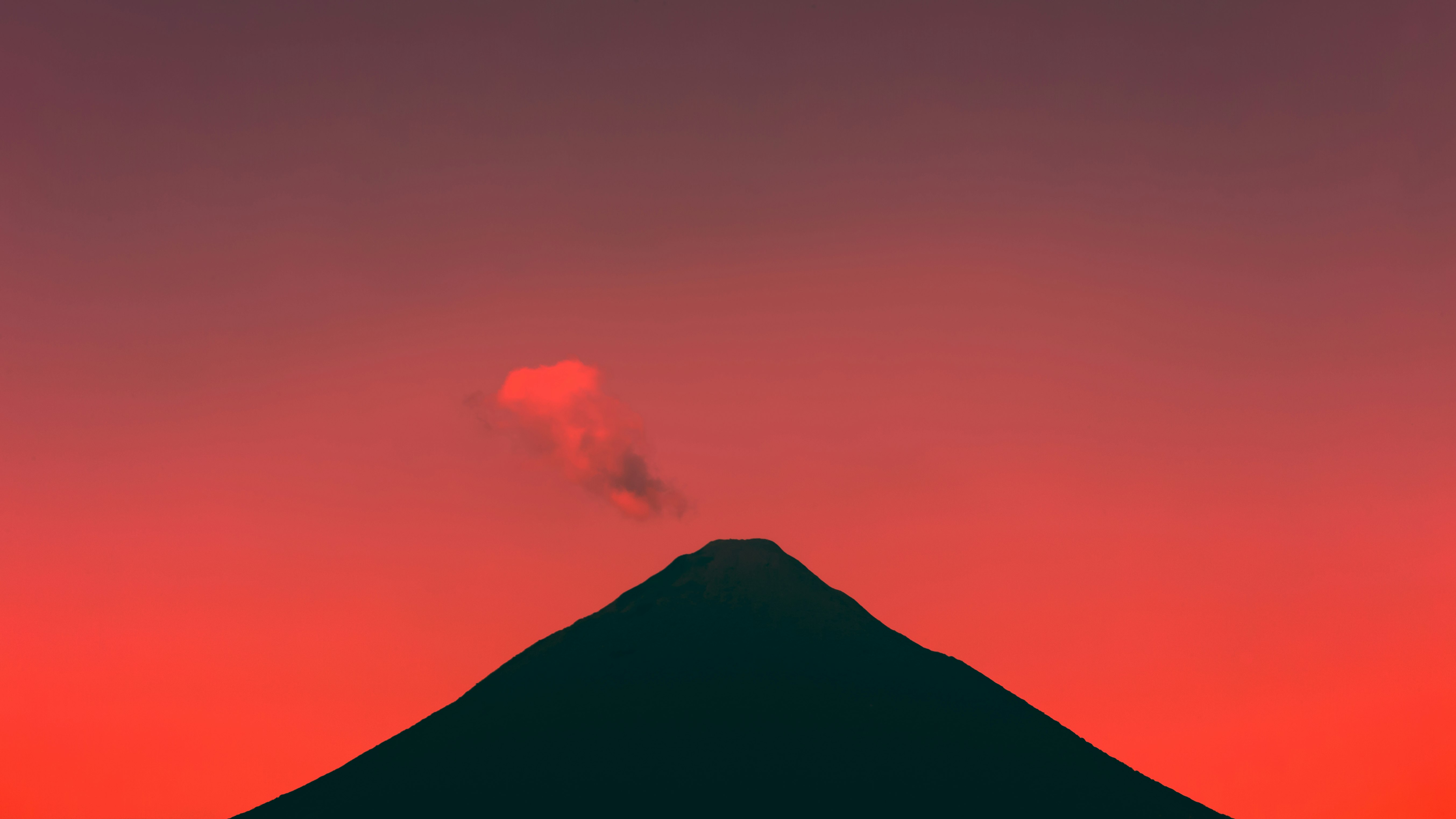 silhouette of mountain under cloudy sky during daytime